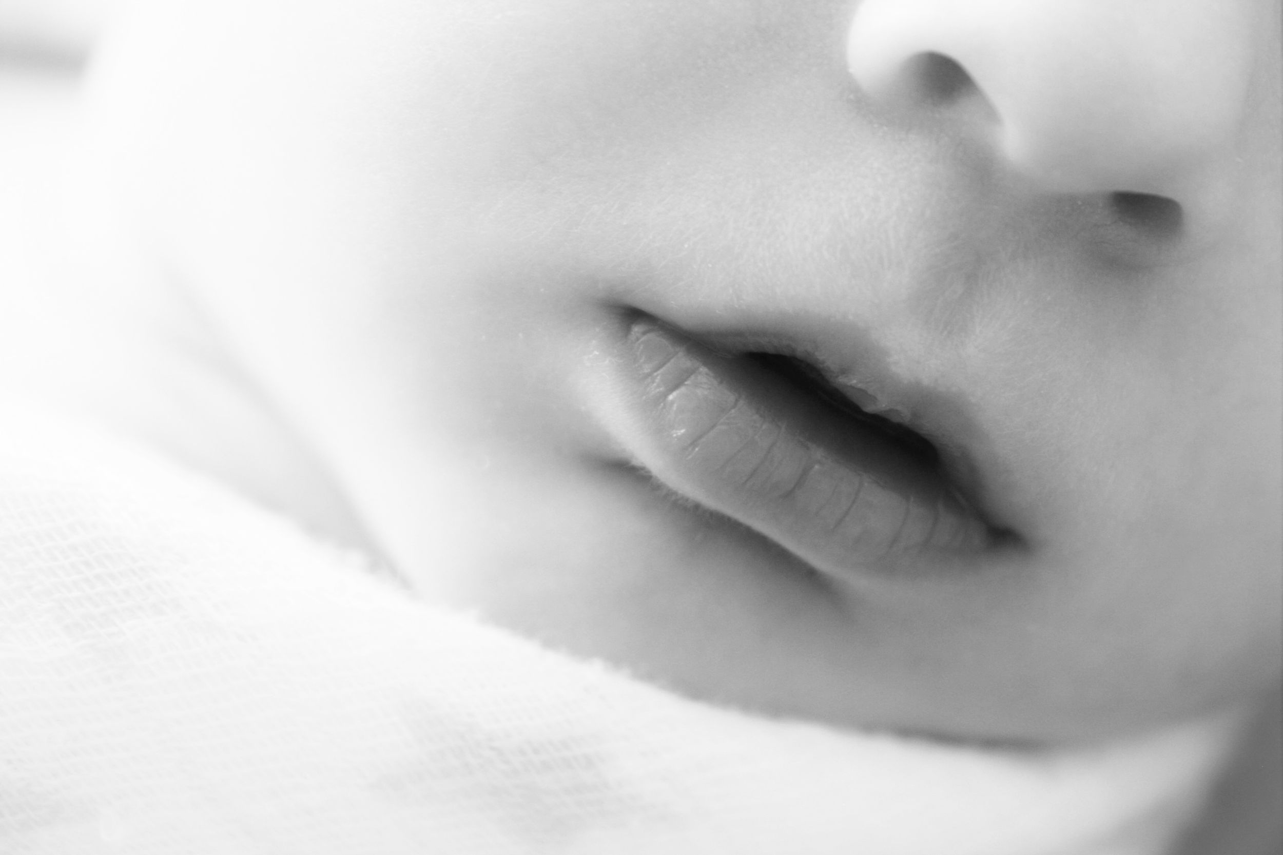 Black and white newborn photography of baby's lips and nose