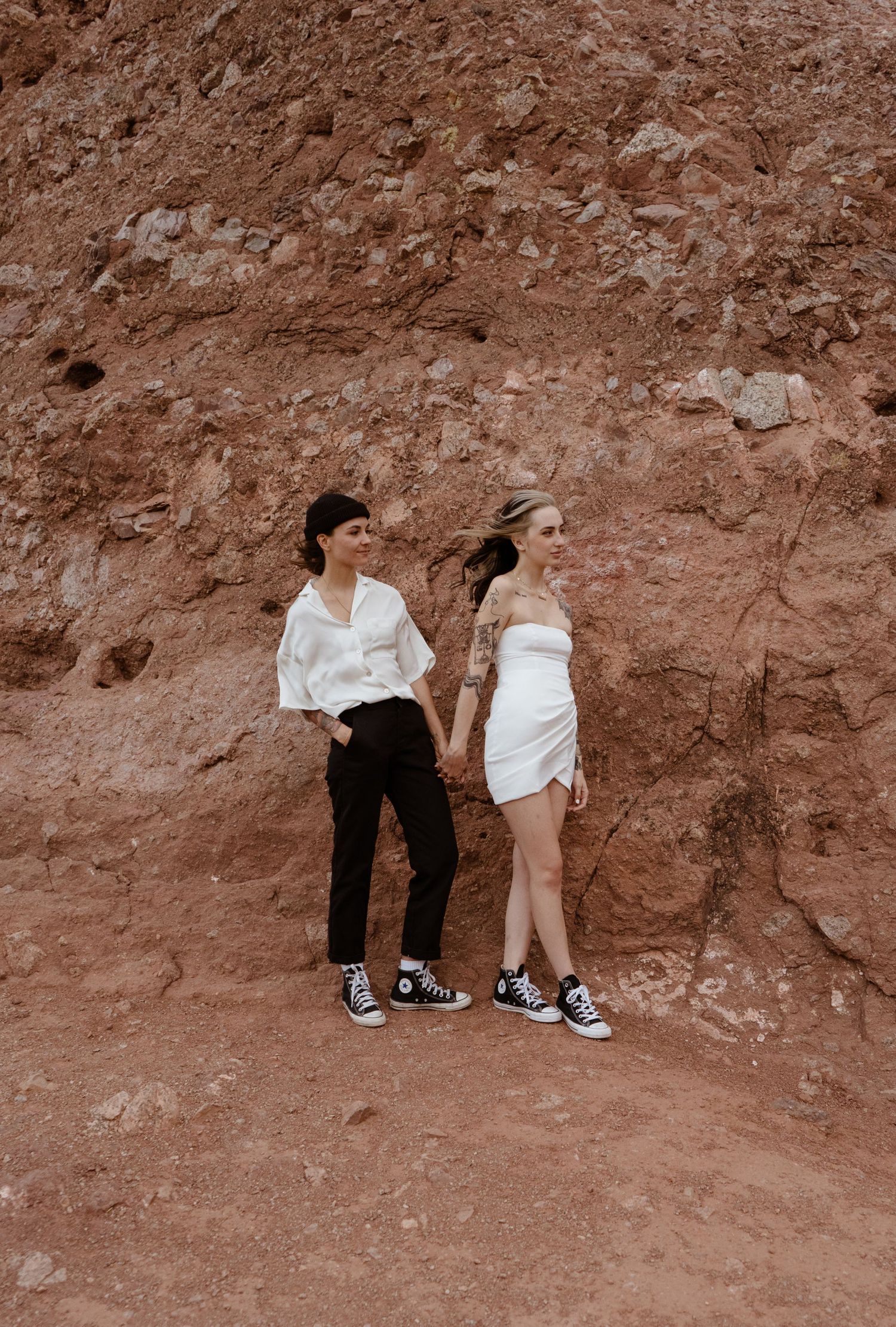 Two brides holding hands after their elopement