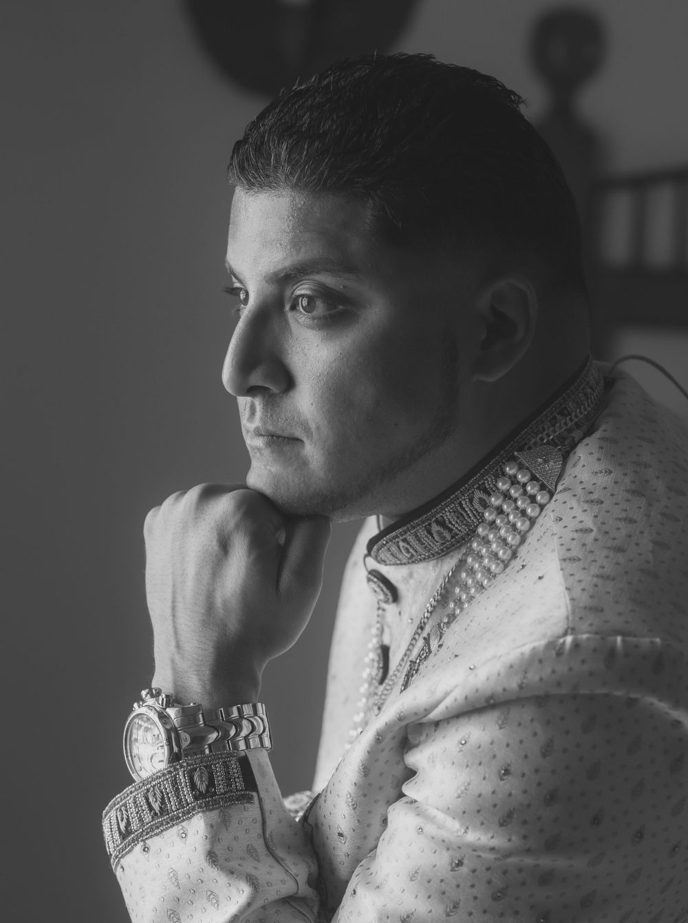 A black and white portrait series showing a pensive figure in a turtleneck sweater looking off to the side.