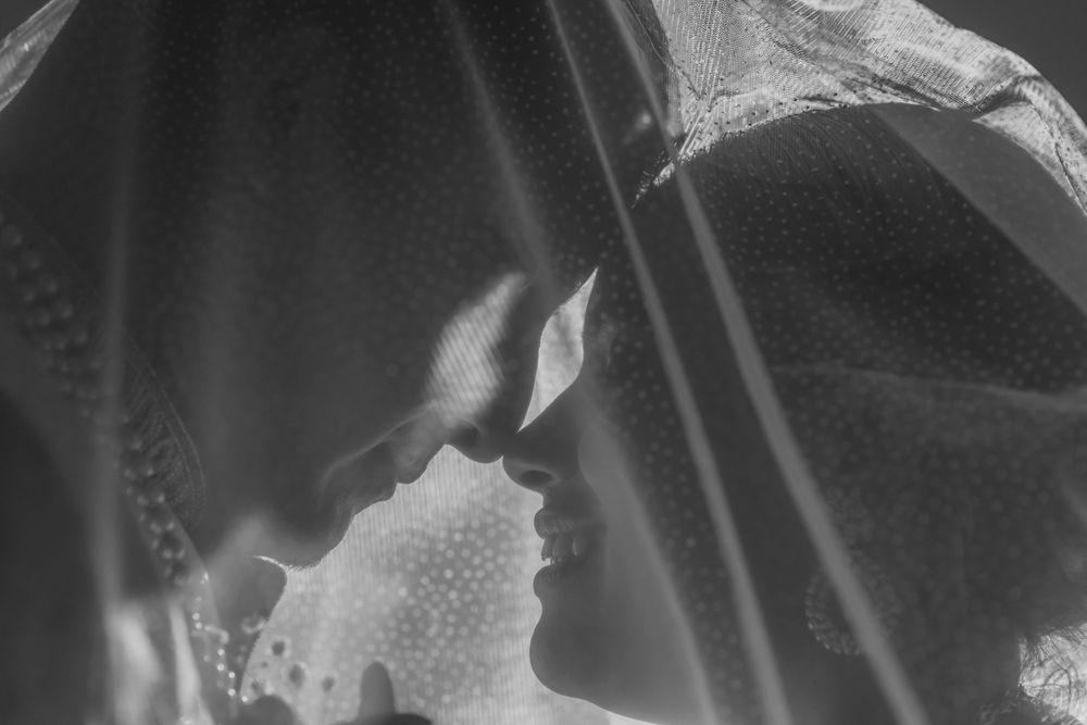 A series of black and white silhouettes show a romantic couple in intimate poses against a light background.