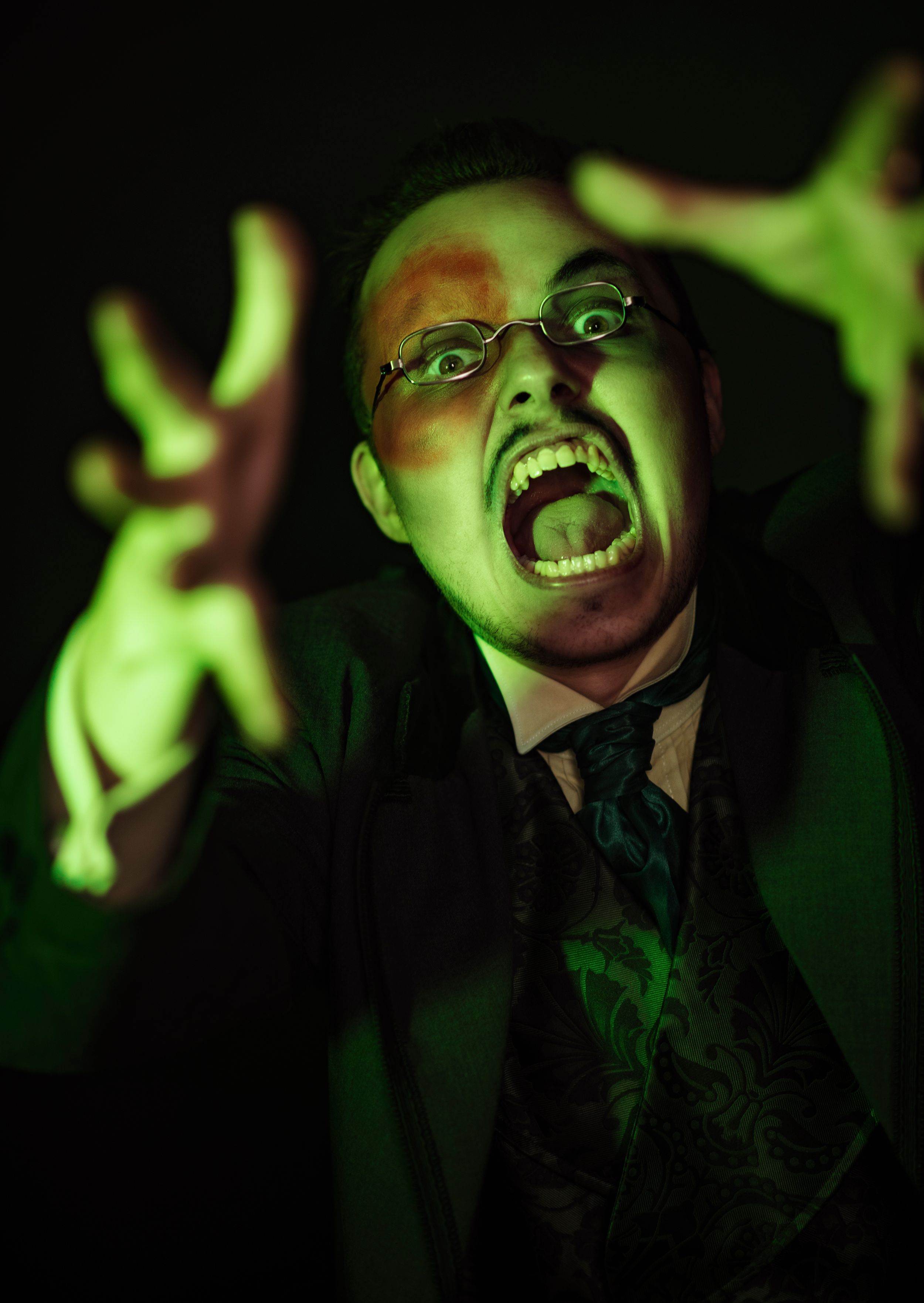 scary green and ghostly man appearing from out of the dark