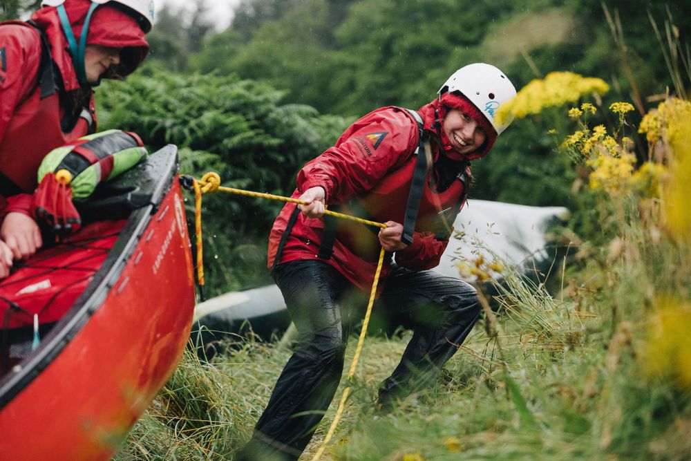 My Adventure canoe student pulls boat onto land