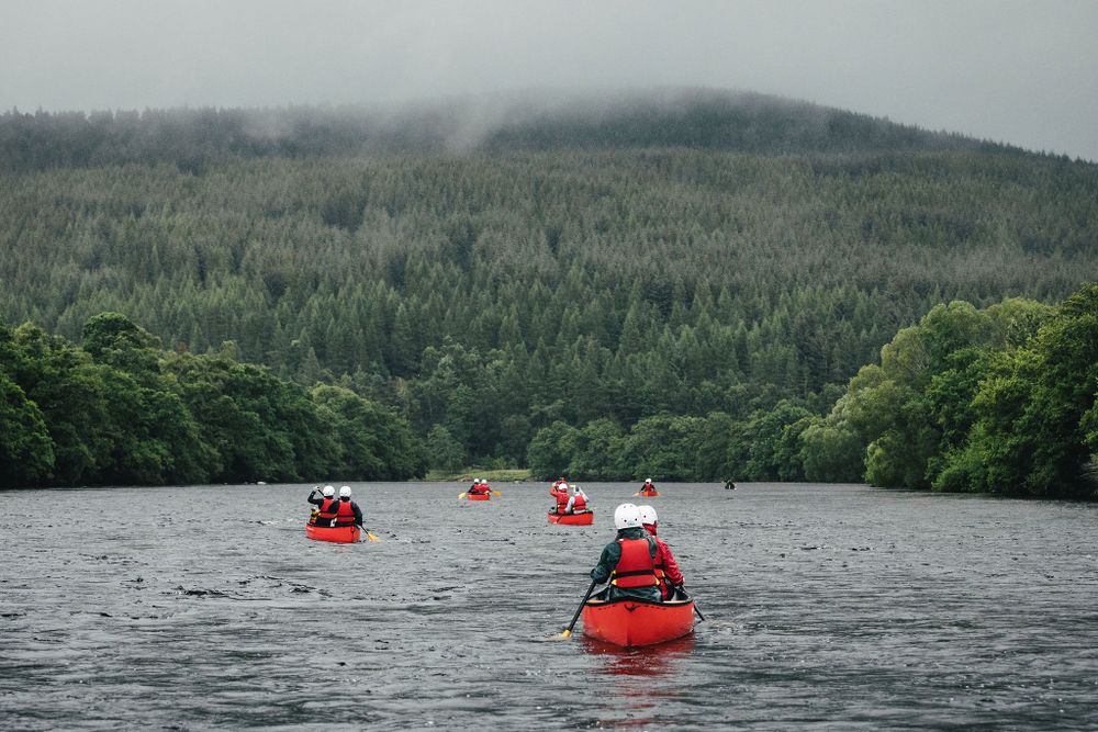 My Adventure canoe students paddle towards wooded area