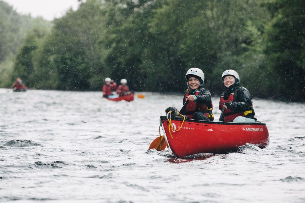 My Adventure students smile as they paddle a canoe