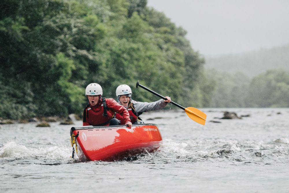 My Adventure two canoe students react as their boat begins to tip over
