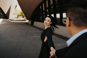 Stylish portrait session featuring elegant attire and modern architectural elements.