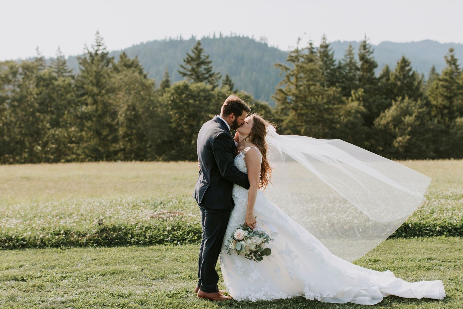 Summer Wedding in Hood River along the Columbia River Gorge at sunset with bride's veil blowing in the wind