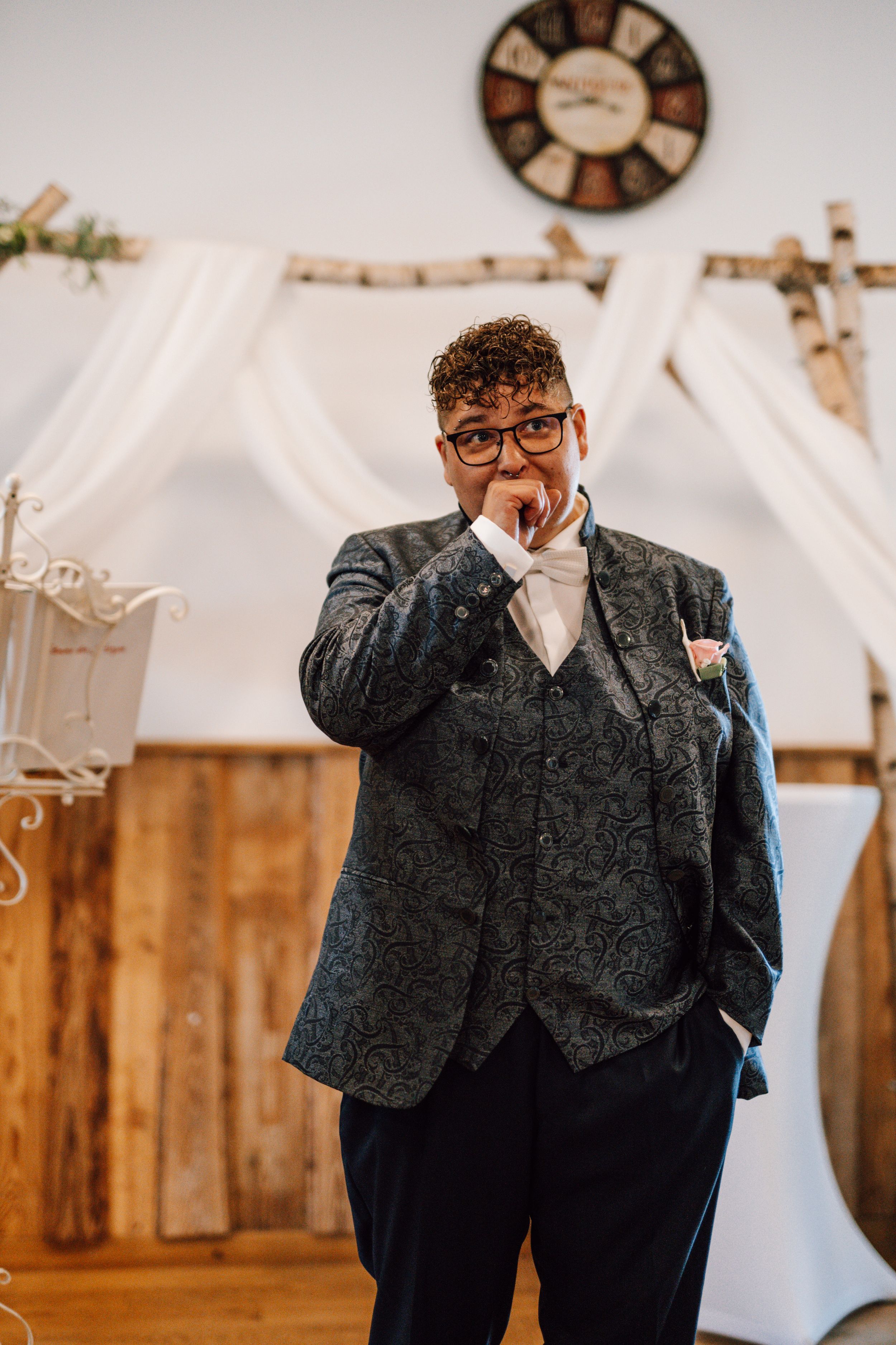 Wedding guest in formal attire showing emotion during ceremony.