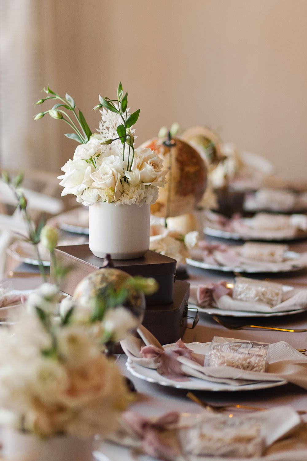 floral arrangements with white roses as part of a guest's table decor of a baby shower in NJ photo by Paula Ortiz