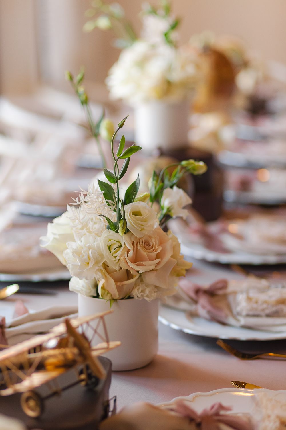 a bokeh view of a rose floral arrangement with florals in the background in neutral brown and beige colors in Verona NJ
