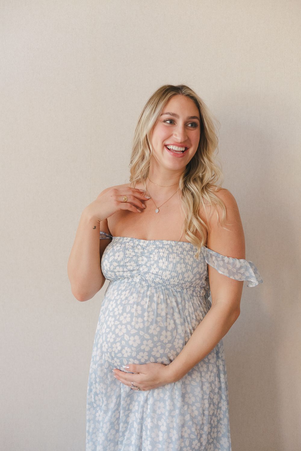 a half body view of a pregnant woman smiling during her baby shower in Verona NJ captured by Paula Ortiz NY Family Photo
