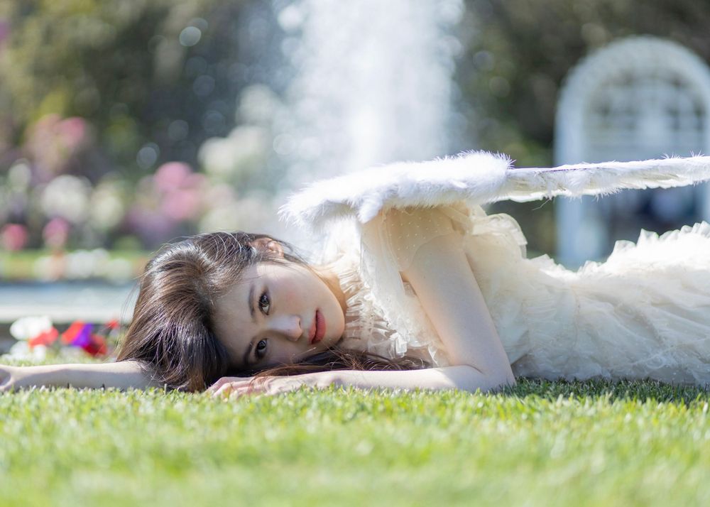 Dreamy garden photoshoot featuring soft grass and delicate poses.