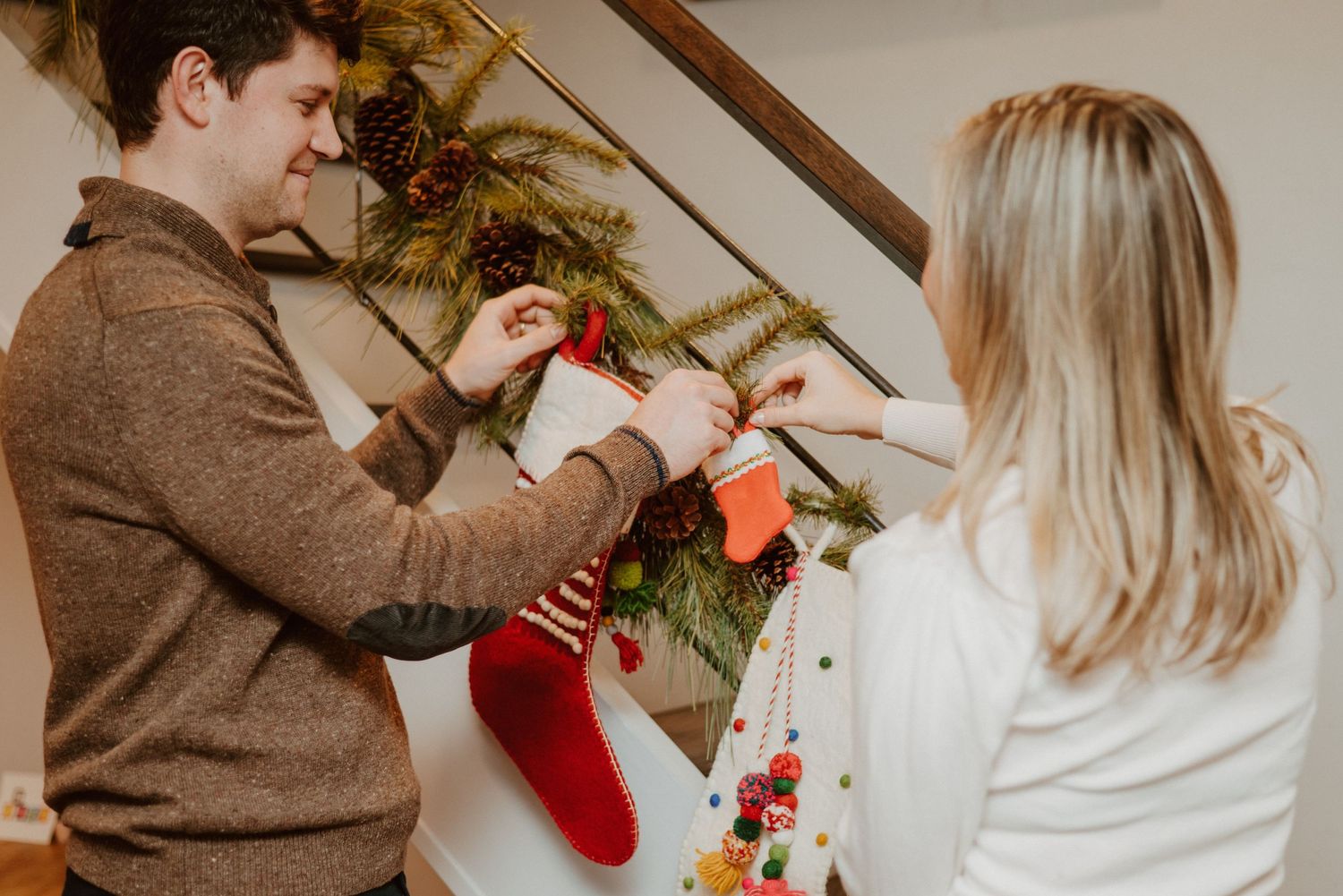 Expecting couple hangs baby stocking up