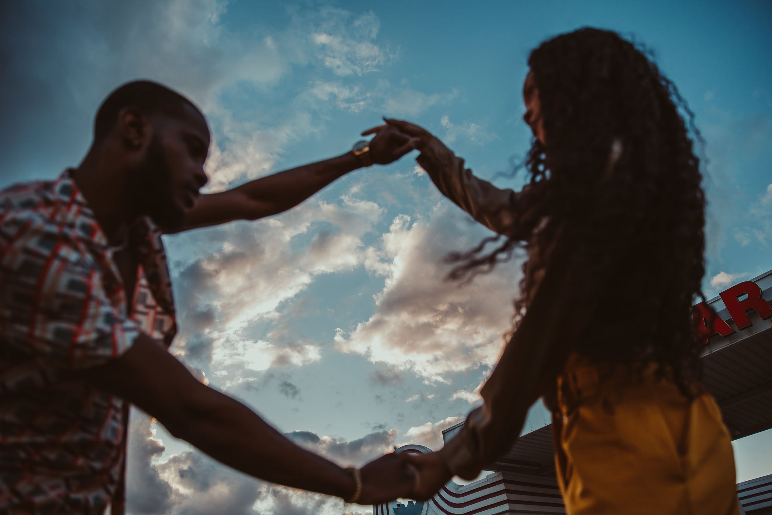 chicago models and chicago couple dancing in sunset with cloudy skies  cinematic storytelling photography