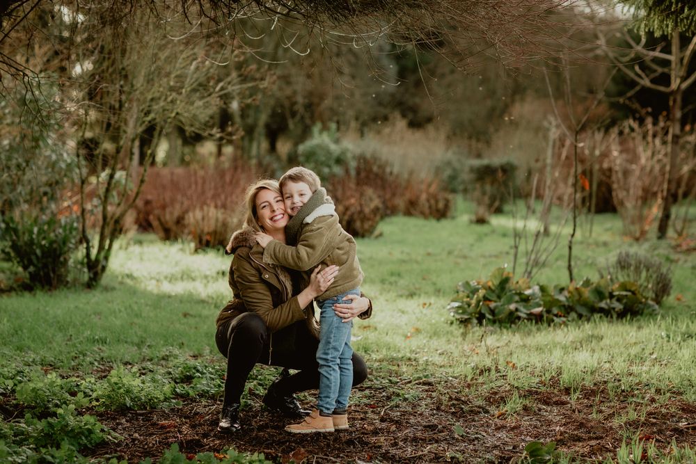 Candid moment of affection captured in a lush green garden setting.