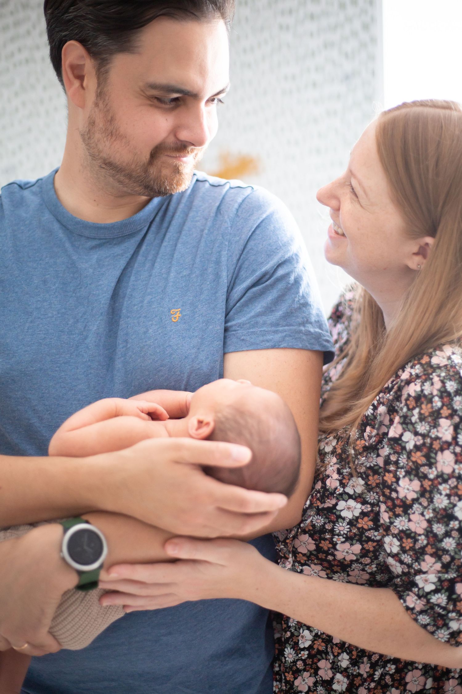 newborn in the arms of parents