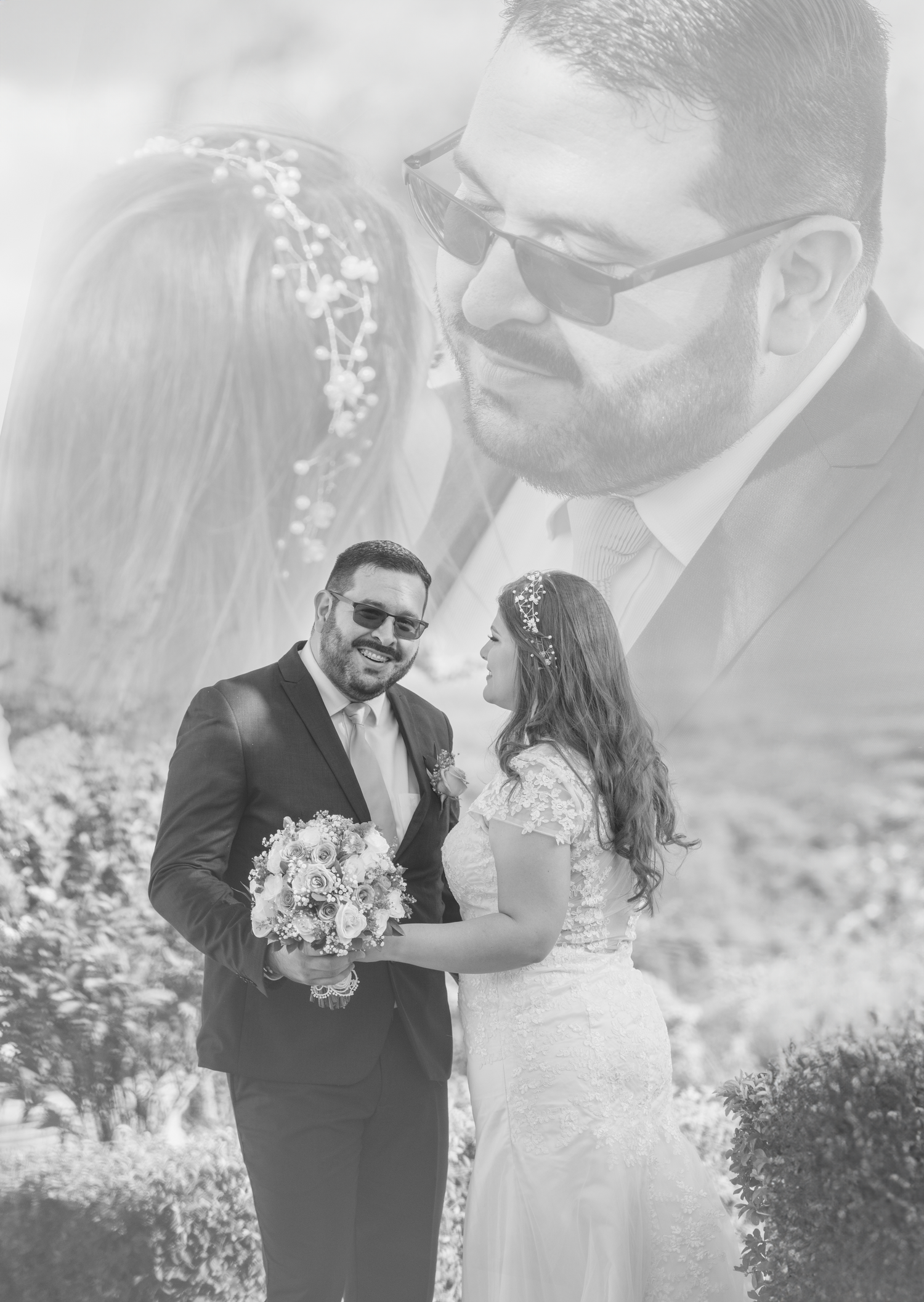 Black and white wedding portrait of couple with floral bouquet in scenic outdoor setting.