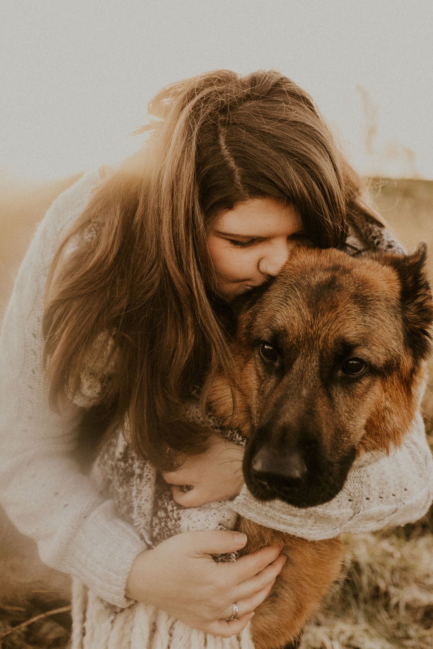 owner giving a cuddle to German shepherd