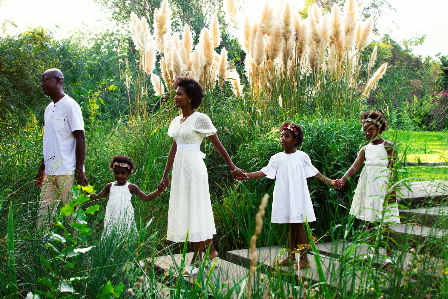 Group photo session in a field of tall pampas grass during golden hour.