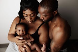 Intimate family portrait against dark background.