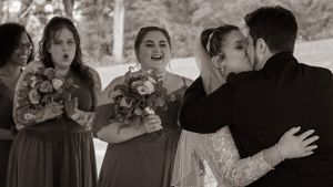 Black and white candid dance floor moments at wedding reception.