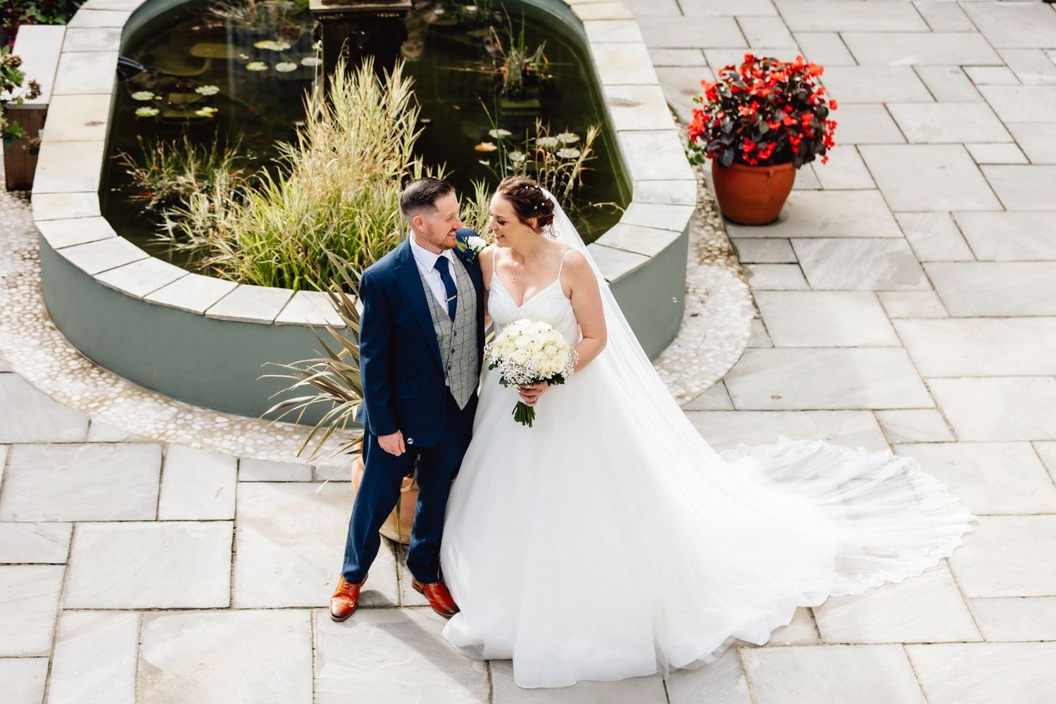 Wedding couple near fountain at Cottesmore Hotel