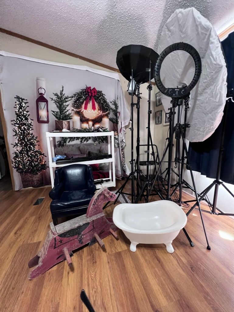 Photography studio setup with lighting equipment, props and Christmas decorations.
