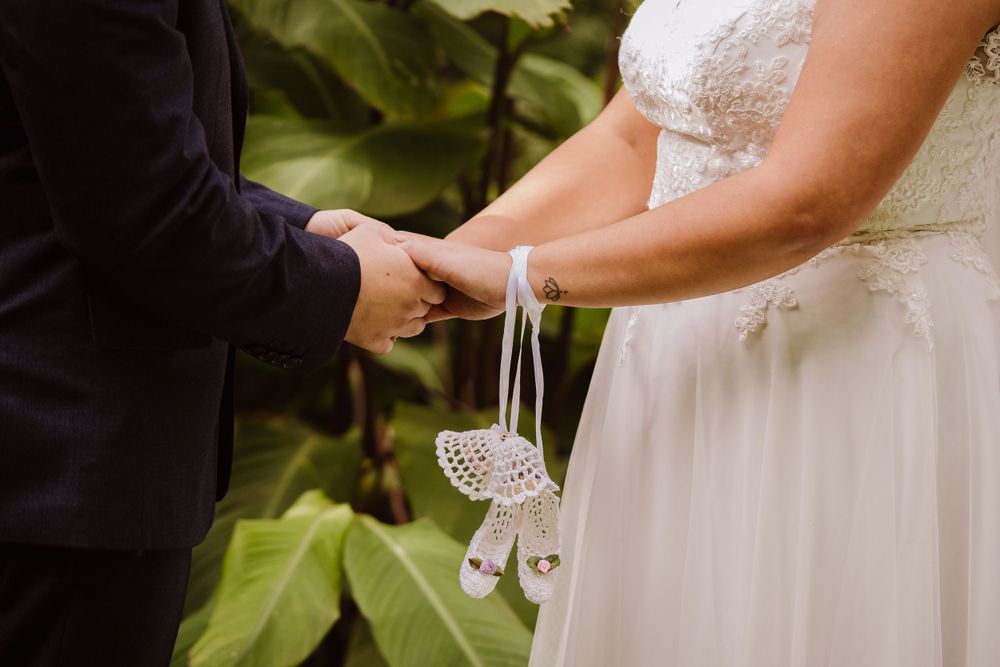 Wedding dress detail with lace trim in natural lighting.