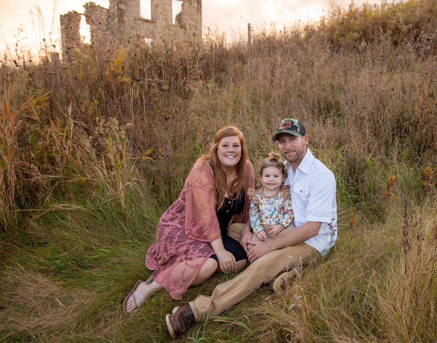 Family sitting in field