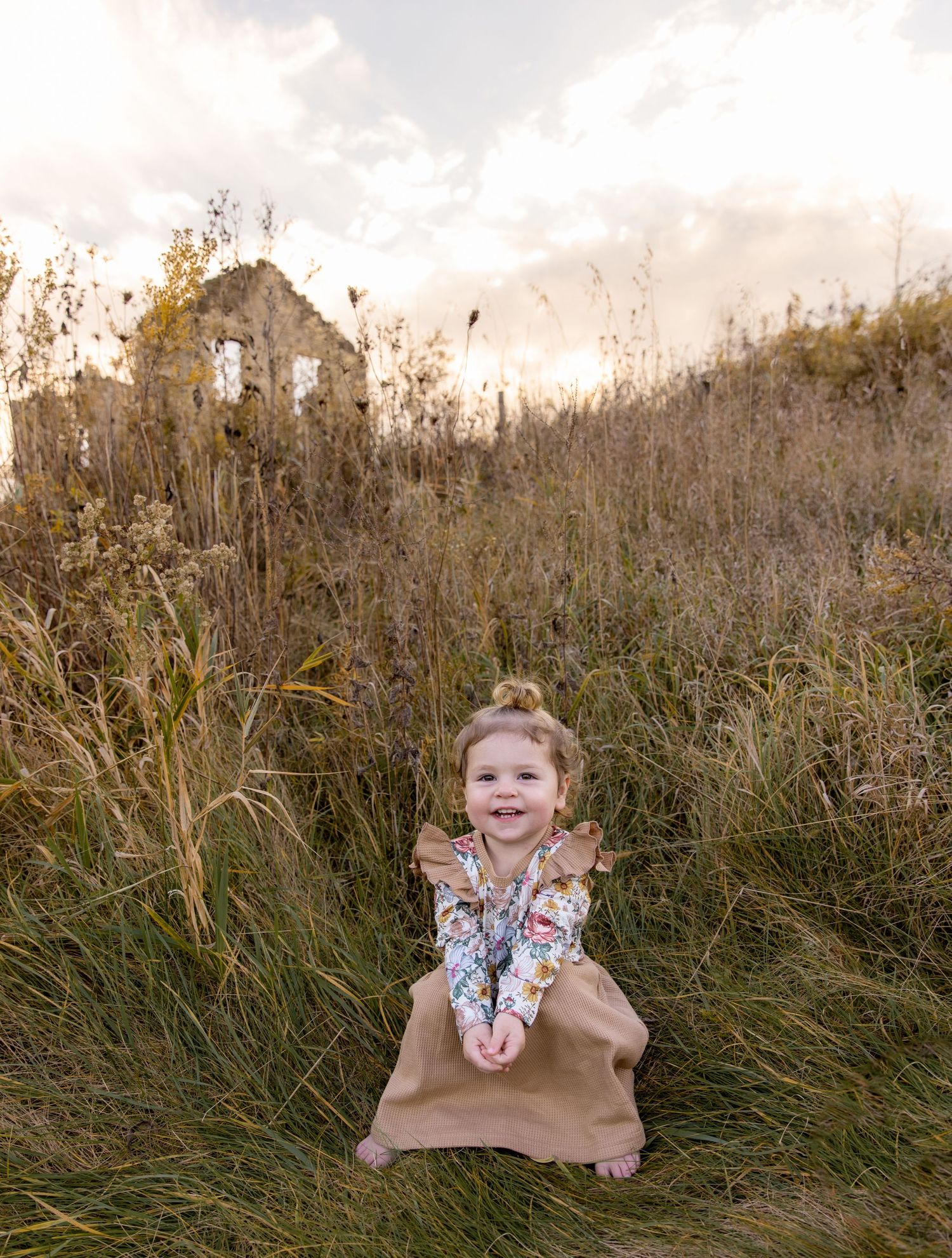 2 year old sitting in field