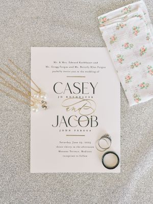 Sparkly wedding details with invitation, rings and jewelry. Classic and film-inspired wedding photography in Madison, Wisconsin.