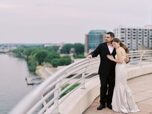 Cozy bride and groom on Monona Terrace rooftop at sunset. Classic and film-inspired wedding photography in Madison, Wisconsin.