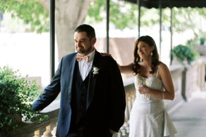 First look bride and groom tap on the shoulder outdoors with emotion. Classic and film-inspired wedding photography in Madison, Wisconsin.