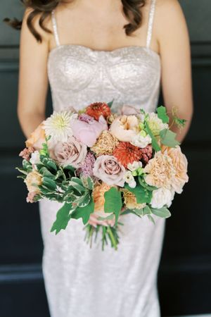 Sparkle wedding dress details with bouquet and dark background. Classic and film-inspired wedding photography in Madison, Wisconsin.