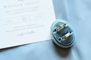 Wedding details with blue ring box, rings and invitation. Classic and film-inspired wedding photography in Madison, Wisconsin.