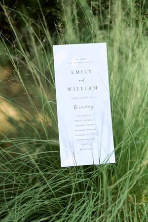Wedding ceremony program printed sitting in long grasses. Classic and film-inspired wedding photography in Madison, Wisconsin.