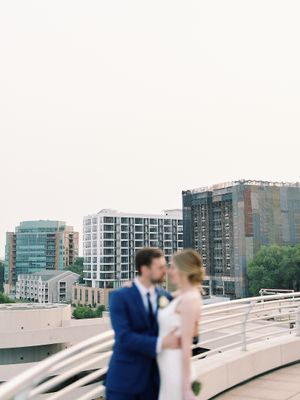 Blurry portrait of bride and groom on the Monona Terrace rooftop. Classic and film-inspired wedding photography in Madison, Wisconsin.