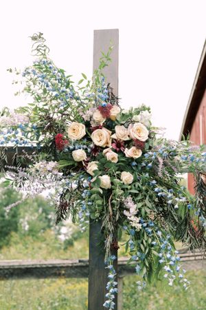 Detail of cross with floral decoration for a wedding ceremony. Classic and film-inspired wedding photography in Madison, Wisconsin.
