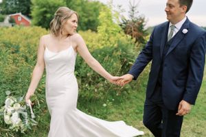 Bride and groom walking candid portrait outdoors on walking path. Classic and film-inspired wedding photography in Madison, Wisconsin.