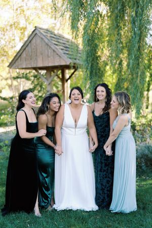 Bridesmaids holding hands laughing candid moment The Rotary Botanical. Classic and film-inspired wedding photography in Madison, Wisconsin.