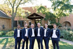 Groom and groomsmen in formal attire at The Rotary Gardens. Classic and film-inspired wedding photography in Madison, Wisconsin.