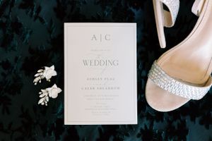 Wedding details with bride's shoes, earrings and save the date. Classic and film-inspired wedding photography in Madison, Wisconsin.