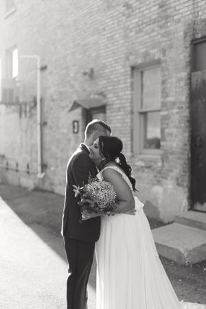 Bride and groom candid portrait in black and white with urban vibe. Classic and film-inspired wedding photography in Madison, Wisconsin.