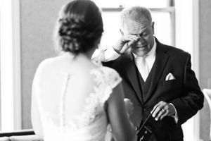 First look bride with father showing emotion wiping away tears. Classic and film-inspired wedding photography in Madison, Wisconsin.