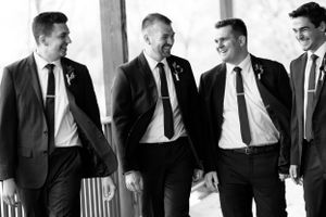 Groomsmen candid black and white walking portrait. Classic and film-inspired wedding photography in Madison, Wisconsin.