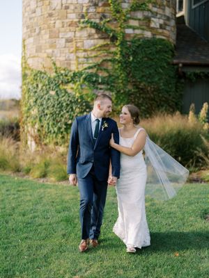 Bride and groom walking at Round Lake Farms in front of ivy and silo. Classic and film-inspired wedding photography in Madison, Wisconsin.