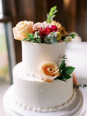 Two-tier wedding cake with real flowers. Classic and film-inspired wedding photography in Madison, Wisconsin.