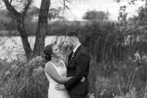 Outdoor fall black and white bride and groom portrait windy weather. Classic and film-inspired wedding photography in Madison, Wisconsin.