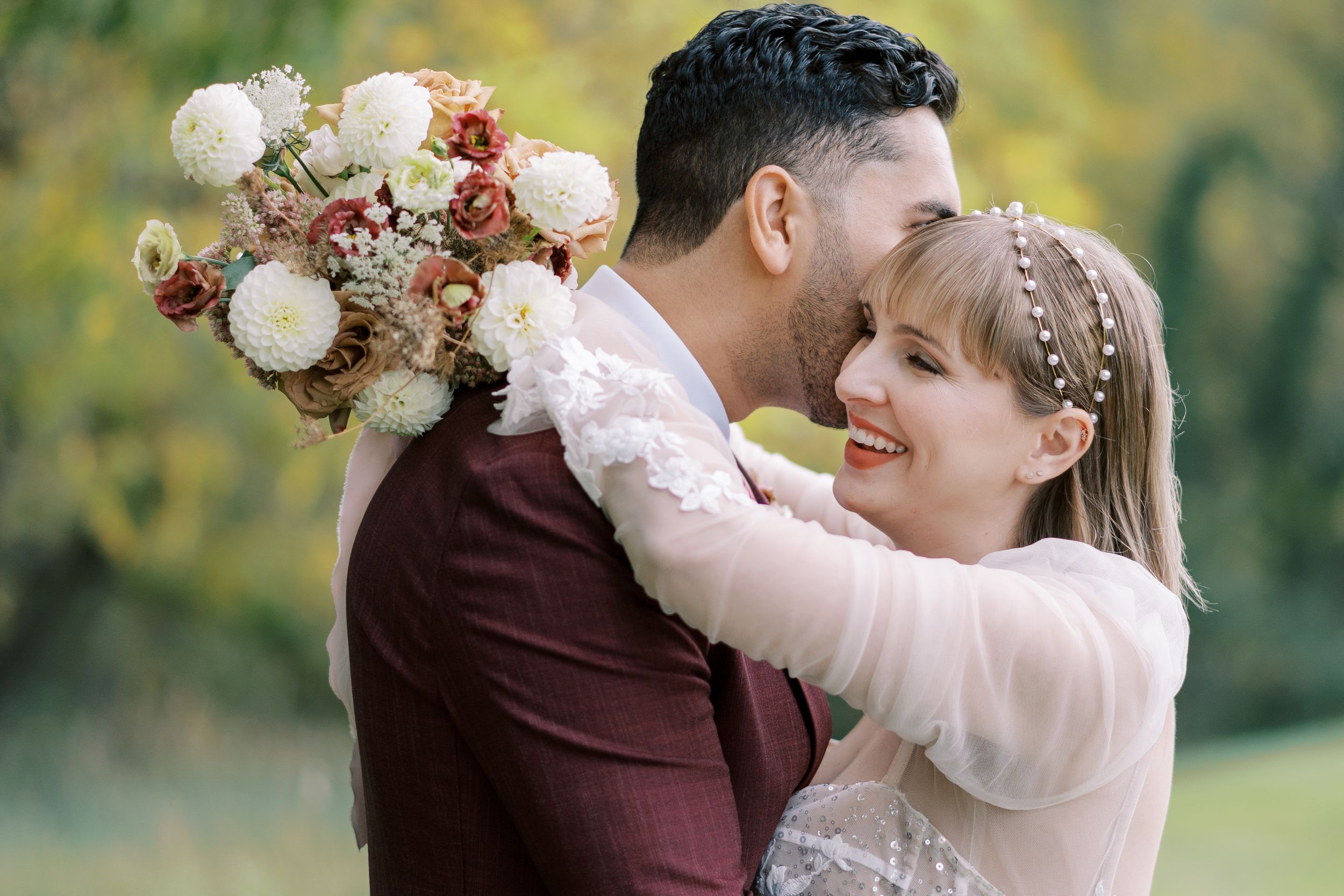 Classic and film-inspired wedding photography in Madison, Wisconsin. Bride and Groom laughing candid portrait with elegant colors.