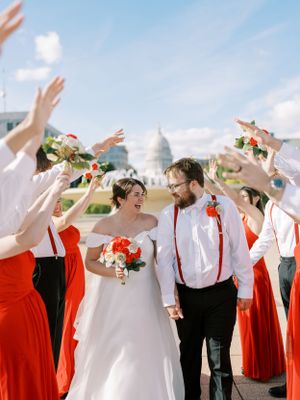 Bride and groom walking through wedding party on Monona Terrace roof. Classic and film-inspired wedding photography in Madison, Wisconsin.